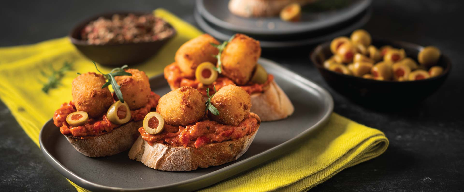 Red Pepper Hummus, Olive And Bruschetta Topped With McCain Cheese Shotz